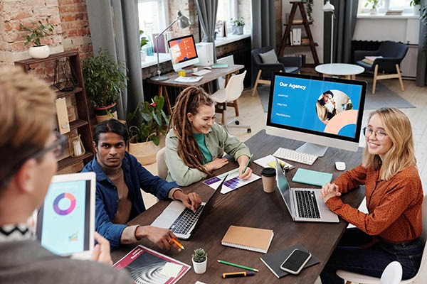 GoHighLevel support team collaborating in a modern agency workspace
